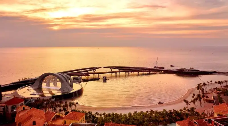 Aerial view of Kiss Bridge Phu Quoc connecting two curved walkways over the sea.