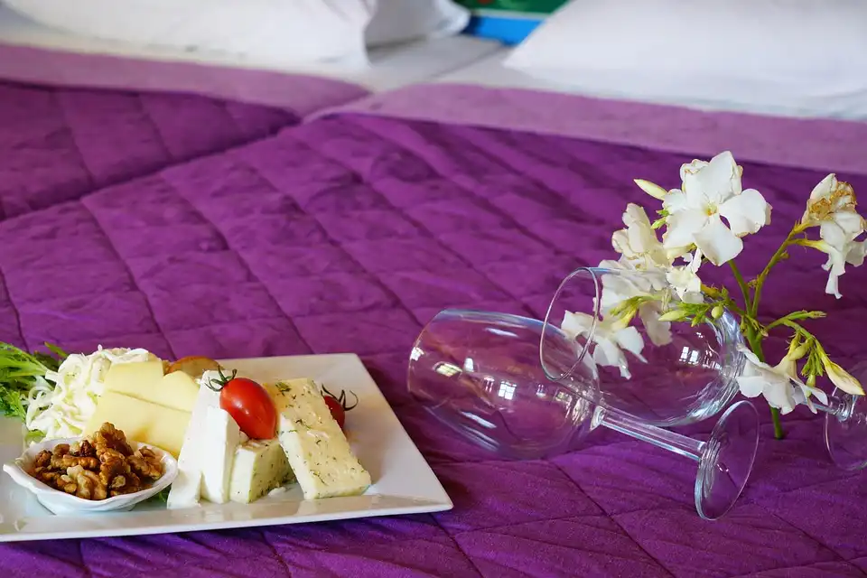 Luxury room setup inside resorts with in-room dining service in Phu Quoc Vietnam, featuring breakfast by the window.